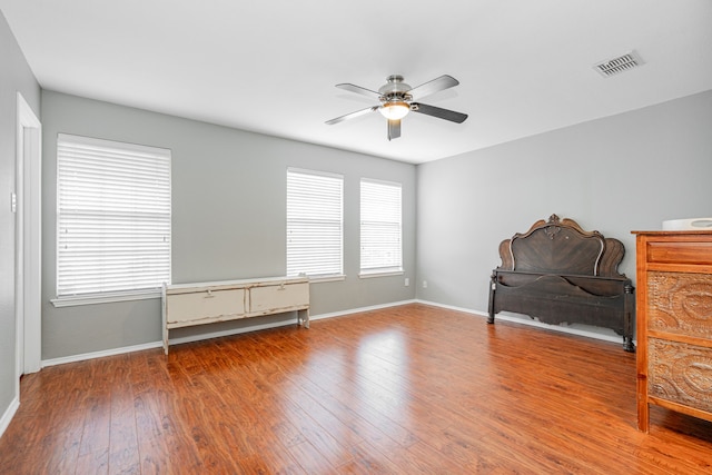 interior space with hardwood / wood-style floors and ceiling fan