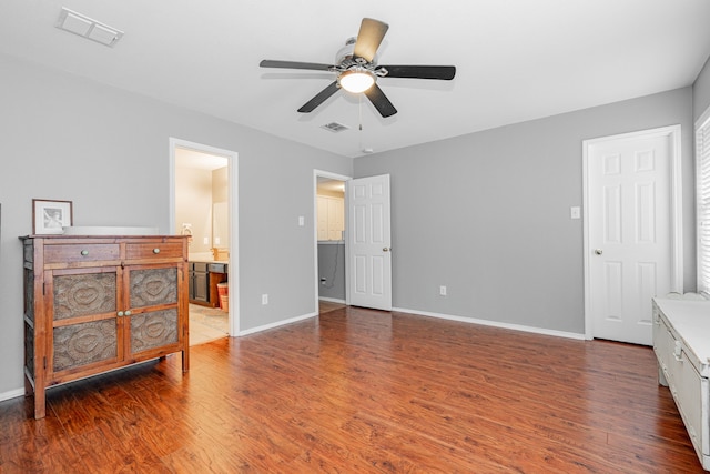 bedroom with ceiling fan, dark hardwood / wood-style floors, and ensuite bath