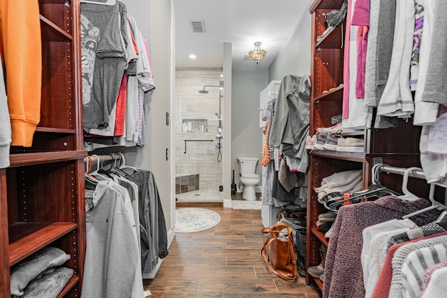 spacious closet featuring dark hardwood / wood-style floors