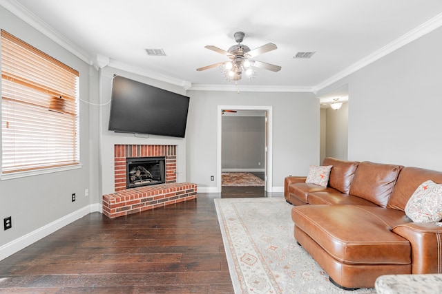 living room with ceiling fan, dark hardwood / wood-style floors, crown molding, and a fireplace