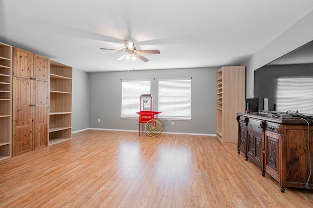 unfurnished living room with ceiling fan and light wood-type flooring