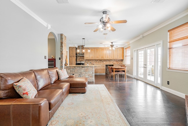 living room with ceiling fan, dark hardwood / wood-style flooring, crown molding, and french doors