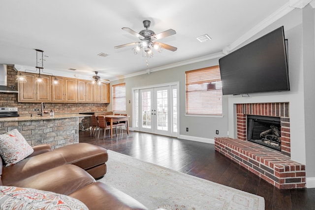 living room with french doors, sink, ceiling fan, ornamental molding, and dark hardwood / wood-style flooring