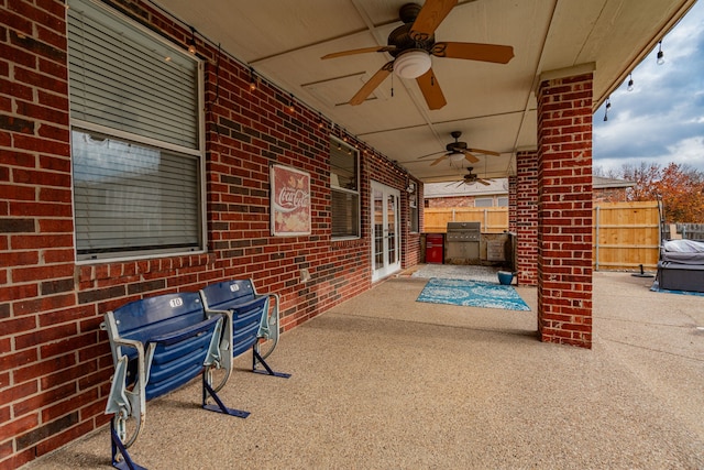 view of patio with a grill, ceiling fan, and an outdoor kitchen