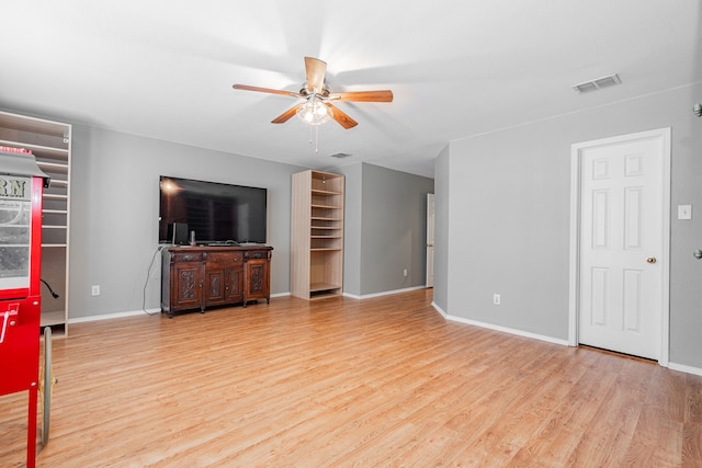 living room featuring ceiling fan and light hardwood / wood-style flooring