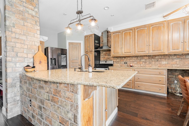 kitchen with light stone countertops, wall chimney range hood, stainless steel appliances, and dark wood-type flooring