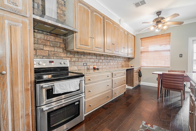 kitchen with wall chimney range hood, dark hardwood / wood-style floors, crown molding, range with two ovens, and light brown cabinetry