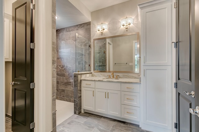 bathroom with vanity and a tile shower