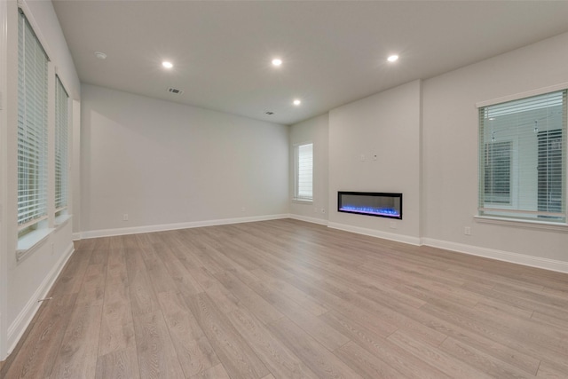 unfurnished living room with light hardwood / wood-style floors