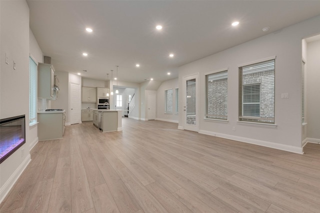 unfurnished living room featuring light wood-type flooring