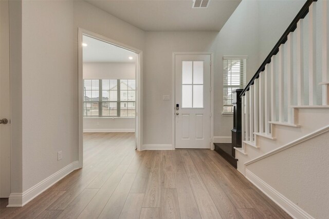 entryway with light hardwood / wood-style floors