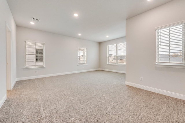 empty room featuring light carpet