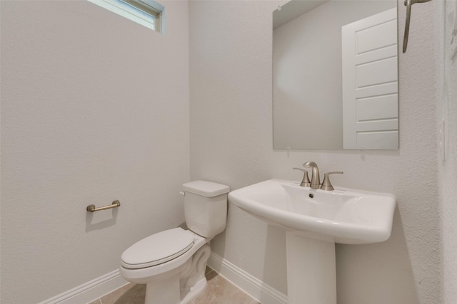 bathroom featuring tile patterned floors and toilet