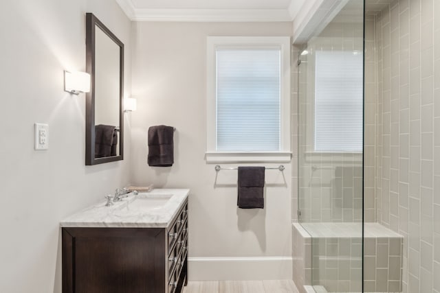 bathroom with ornamental molding, a tile shower, and vanity