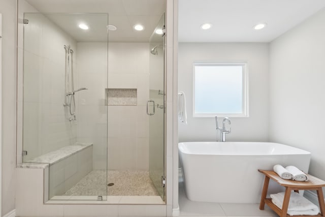 bathroom with separate shower and tub and tile patterned floors