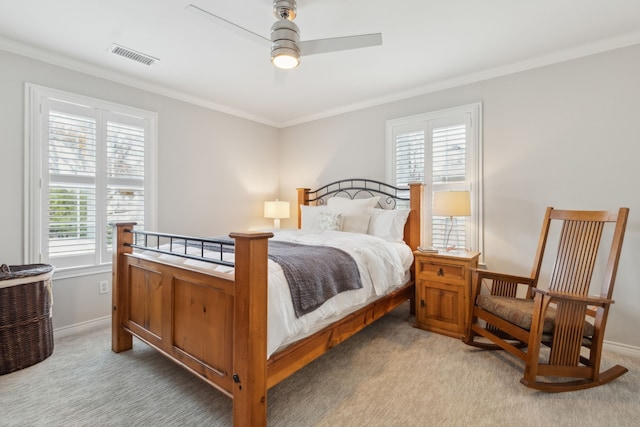 bedroom with ceiling fan, ornamental molding, carpet floors, and multiple windows