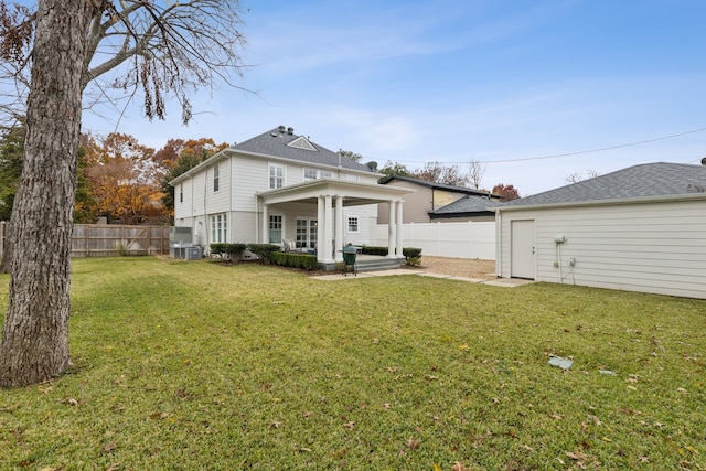 back of house with a lawn