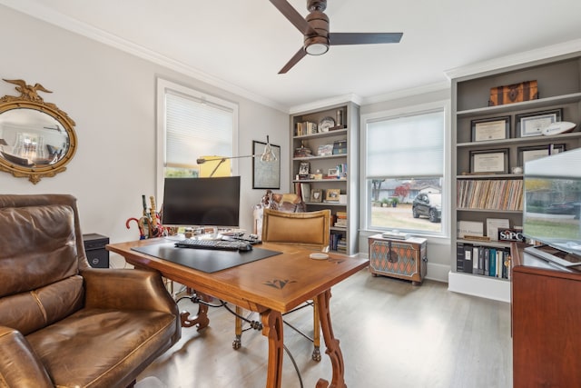 office with crown molding, a healthy amount of sunlight, and hardwood / wood-style floors