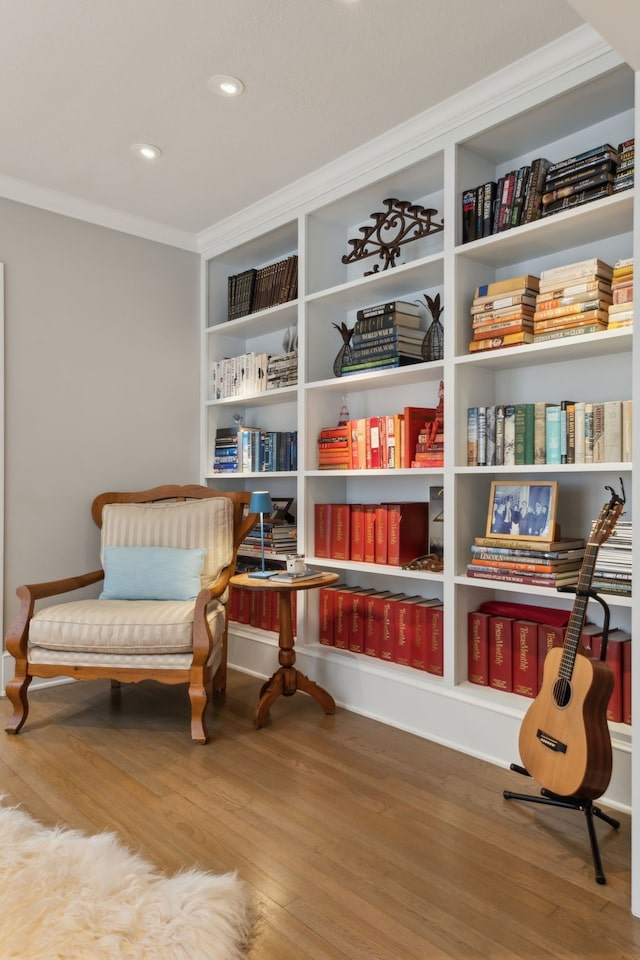 sitting room featuring hardwood / wood-style flooring and crown molding