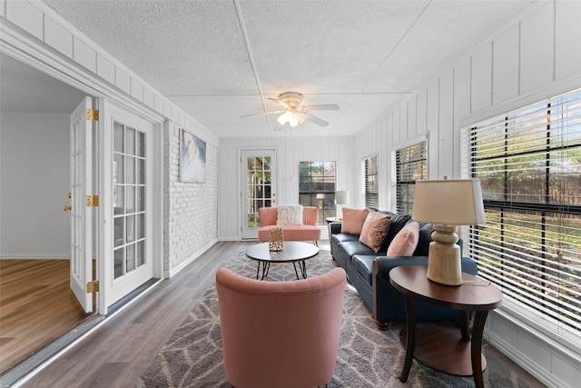 sunroom featuring a wealth of natural light and ceiling fan