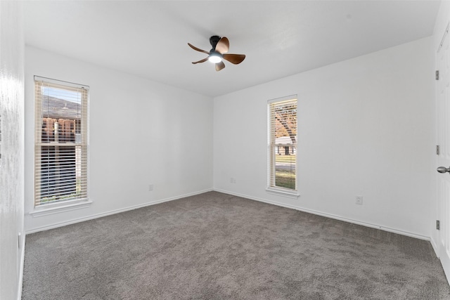 empty room with ceiling fan and carpet floors