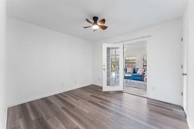 empty room featuring french doors, dark hardwood / wood-style flooring, and ceiling fan