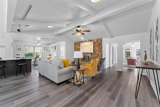 living room with a fireplace, lofted ceiling with beams, and dark wood-type flooring