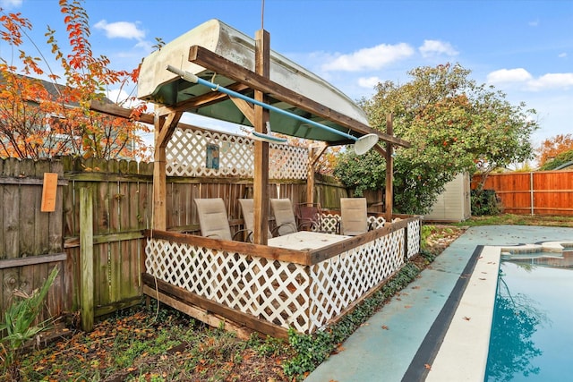 wooden deck with a patio area and an empty pool