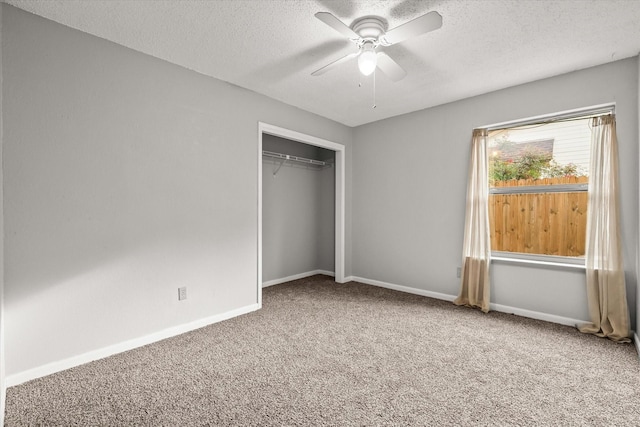 unfurnished bedroom with ceiling fan, a closet, carpet floors, and a textured ceiling