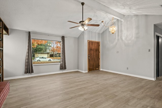 spare room with vaulted ceiling with beams, ceiling fan, a textured ceiling, and hardwood / wood-style flooring