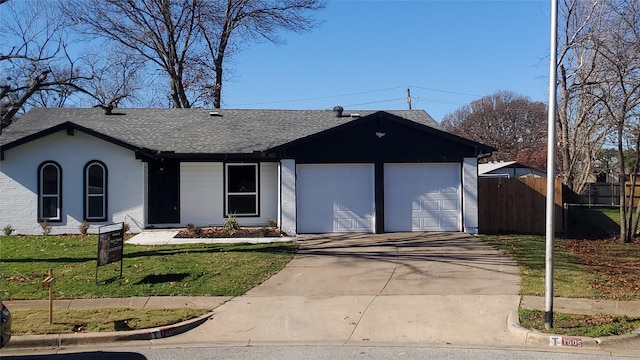 ranch-style home featuring a garage and a front yard