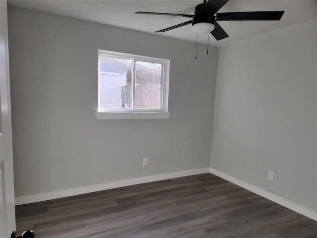 empty room with ceiling fan and dark wood-type flooring