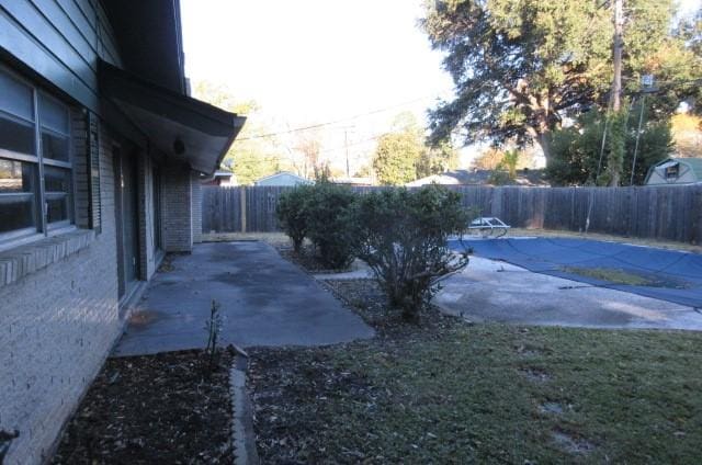 view of yard featuring a patio and a covered pool