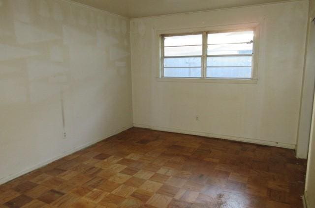 spare room with dark parquet flooring