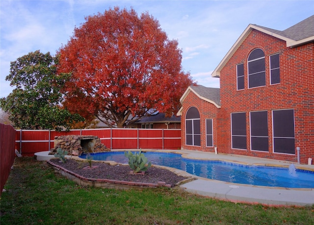 view of swimming pool with pool water feature