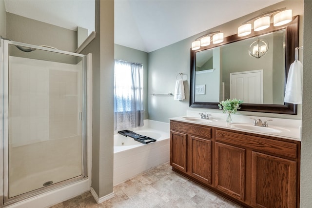 bathroom featuring a notable chandelier, vanity, and independent shower and bath