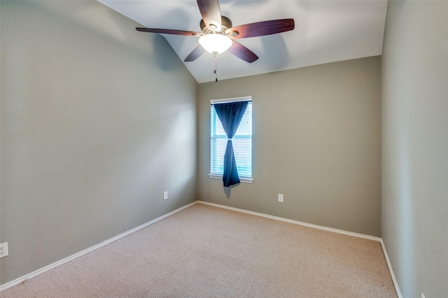 carpeted empty room with ceiling fan and vaulted ceiling