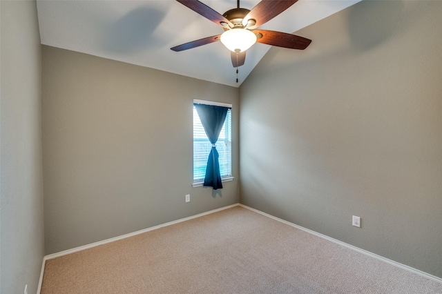 spare room with ceiling fan, carpet, and vaulted ceiling