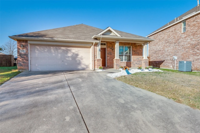 view of front of property featuring central AC, a garage, and a front lawn