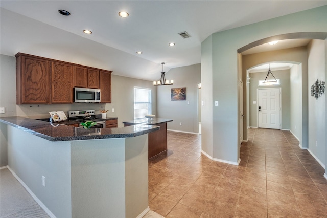 kitchen with pendant lighting, appliances with stainless steel finishes, a notable chandelier, light tile patterned flooring, and kitchen peninsula