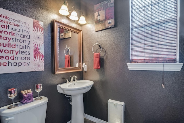 bathroom featuring toilet and sink