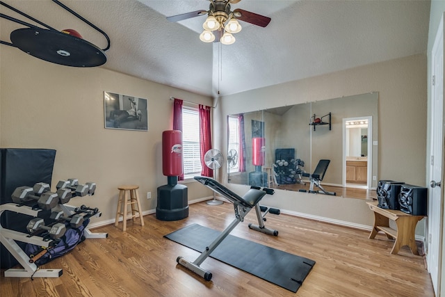 exercise area with a textured ceiling, hardwood / wood-style flooring, and ceiling fan