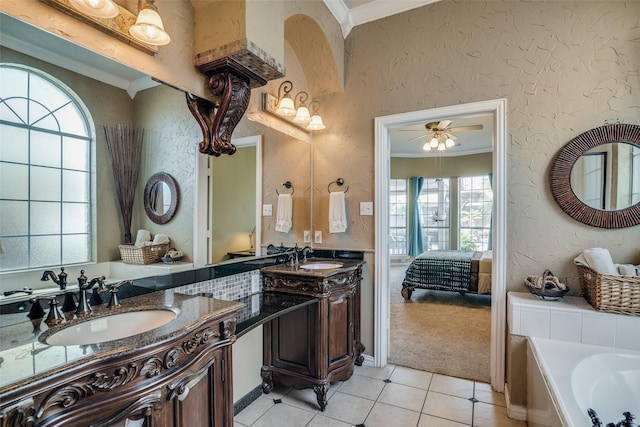 bathroom with tile patterned flooring, plenty of natural light, crown molding, and vanity