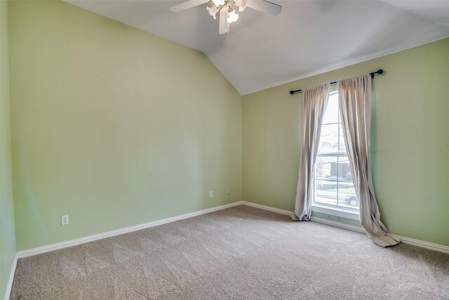 carpeted spare room featuring ceiling fan and vaulted ceiling