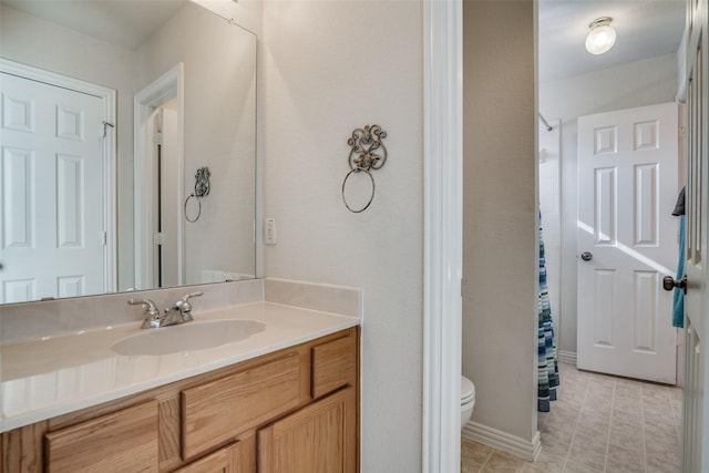 bathroom with curtained shower, vanity, and toilet