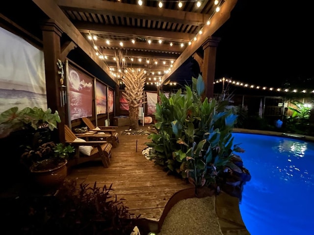 pool at twilight featuring a wooden deck