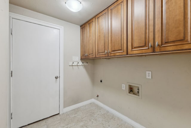 clothes washing area with cabinets, hookup for a gas dryer, hookup for a washing machine, a textured ceiling, and hookup for an electric dryer