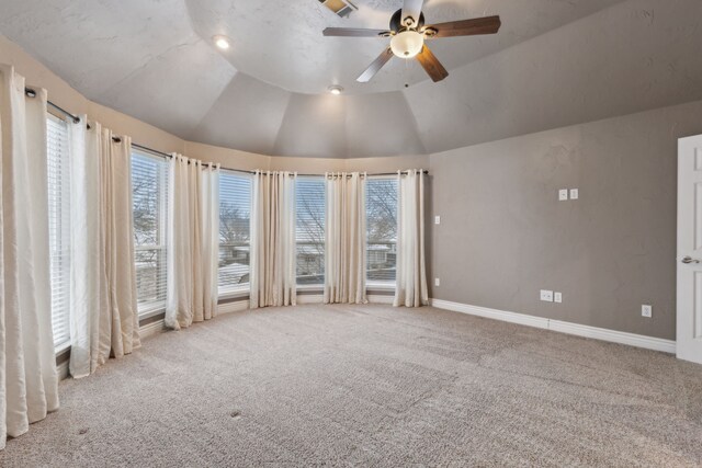 spare room featuring ceiling fan, light colored carpet, and vaulted ceiling