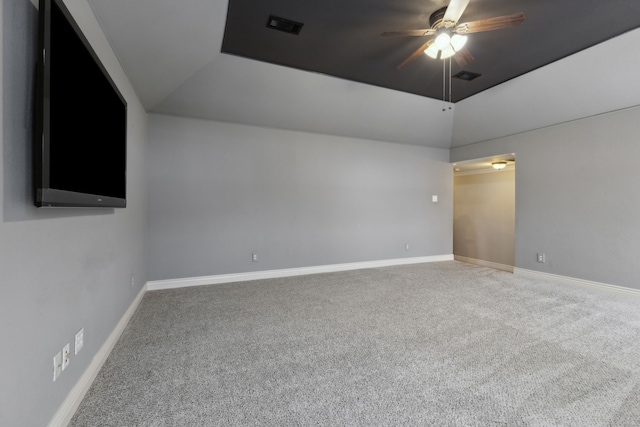 unfurnished room with carpet flooring, a tray ceiling, and ceiling fan