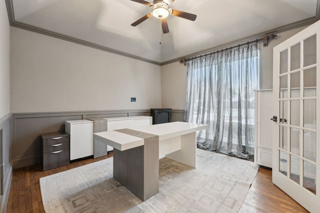 office space featuring ceiling fan, wood-type flooring, crown molding, and lofted ceiling